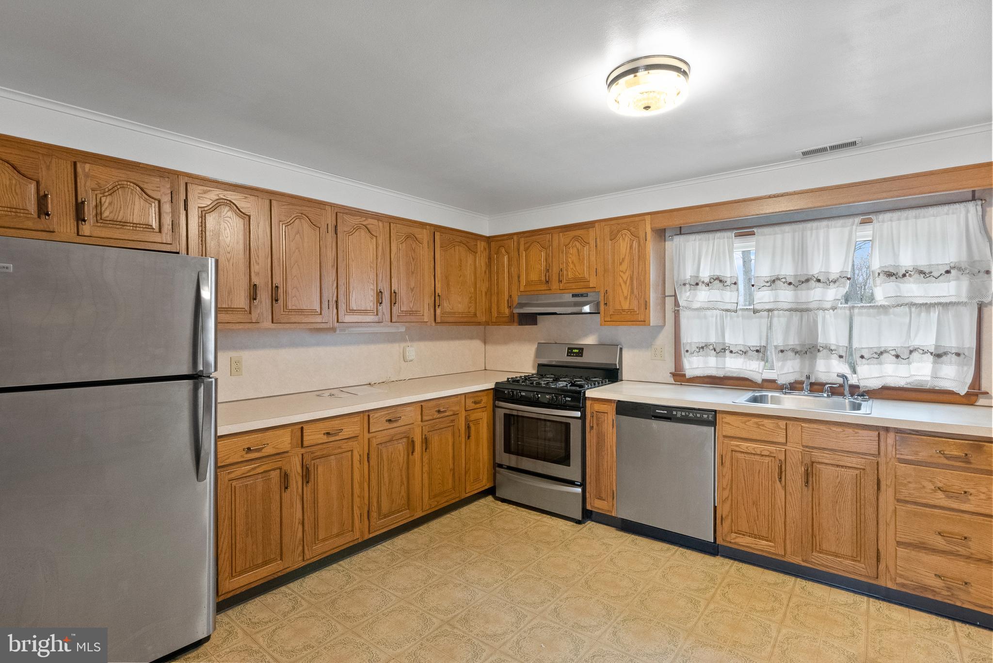1155 South Fairview Street Delran, NJ 08075 - Photo 9 of 24 a kitchen with stainless steel appliances granite countertop a refrigerator a sink dishwasher a stove with wooden cabinets and a refrigerator