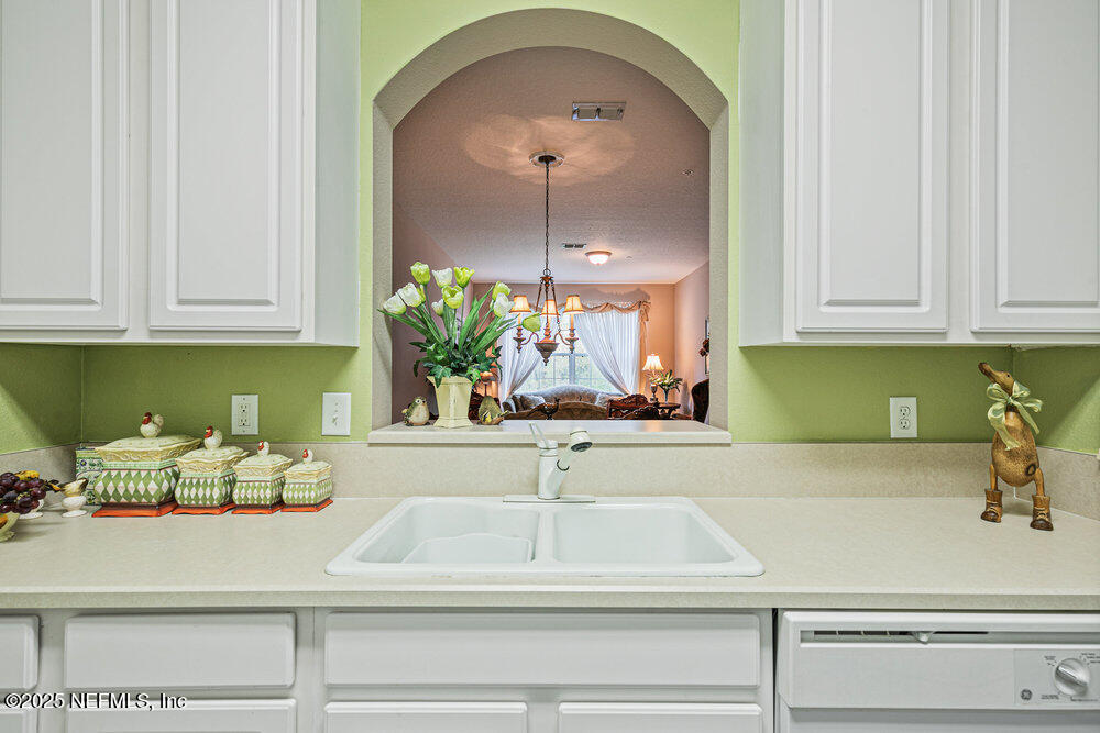 7801 Point Meadows Drive, Unit 3209 Jacksonville, FL 32256 - Photo 12 of 34 a kitchen with a sink and cabinets