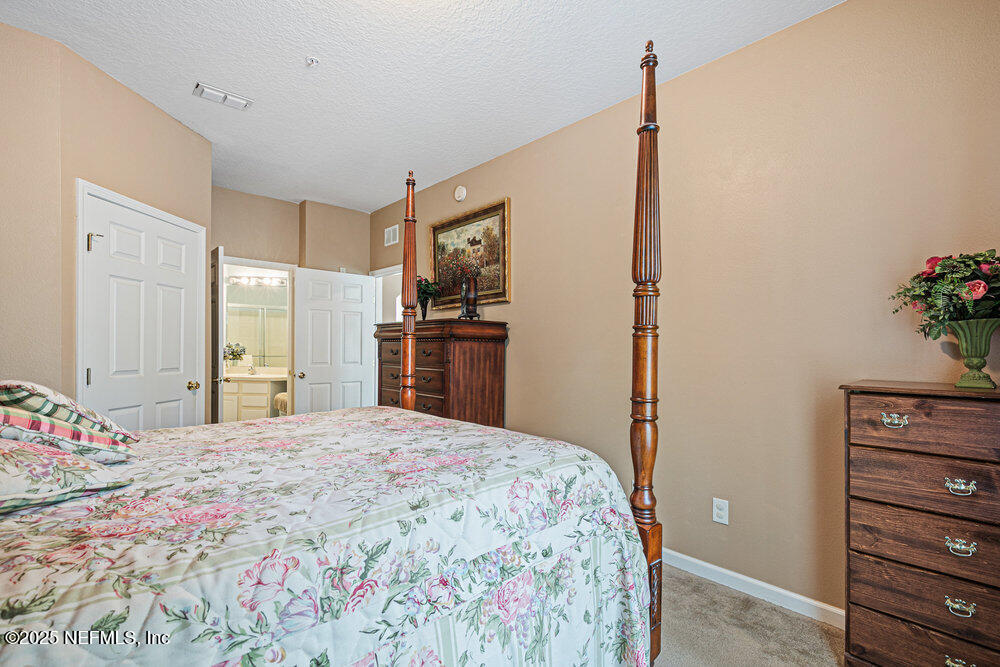 7801 Point Meadows Drive, Unit 3209 Jacksonville, FL 32256 - Photo 18 of 34 a bedroom with a bed and a dresser