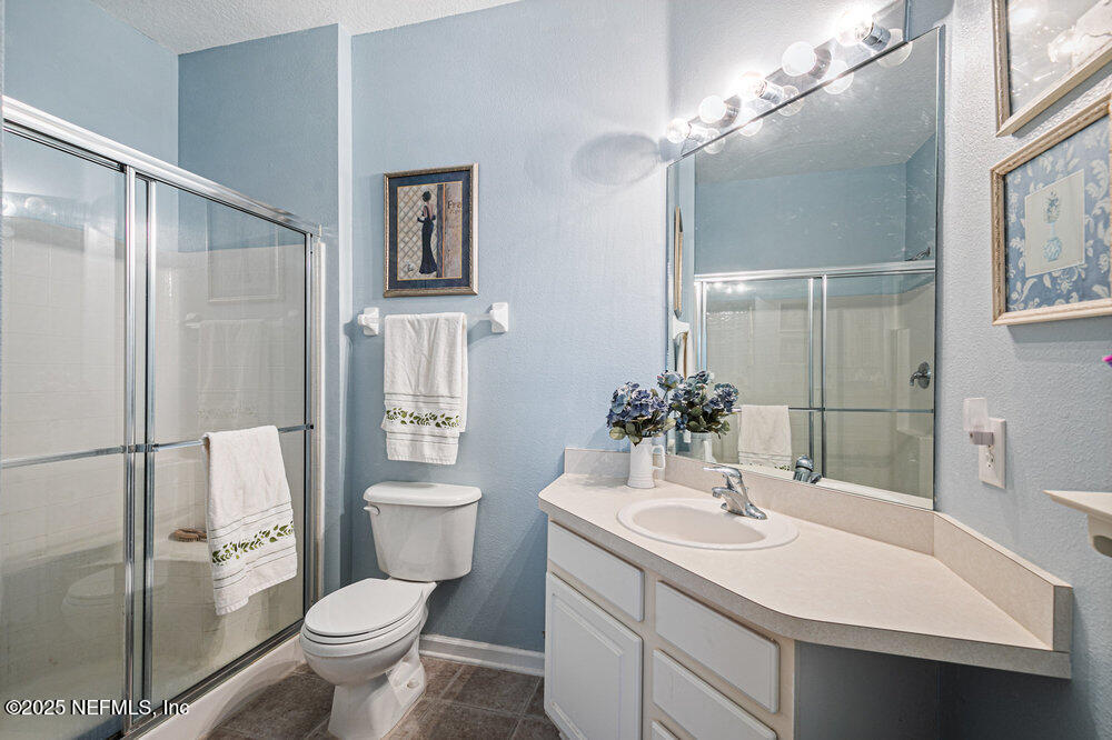 7801 Point Meadows Drive, Unit 3209 Jacksonville, FL 32256 - Photo 19 of 34 a bathroom with a sink toilet and shower