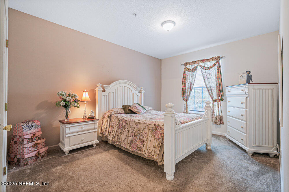 7801 Point Meadows Drive, Unit 3209 Jacksonville, FL 32256 - Photo 20 of 34 a room with a bed and a baby crib