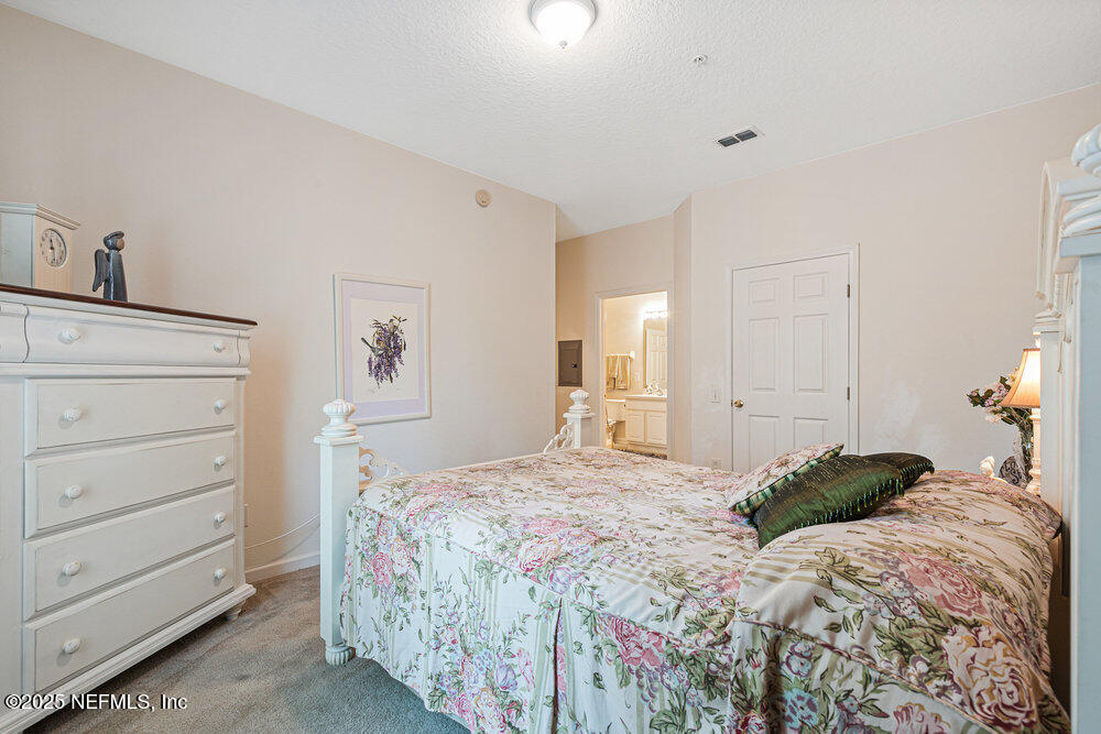 7801 Point Meadows Drive, Unit 3209 Jacksonville, FL 32256 - Photo 21 of 34 a bedroom with a bed and a dresser