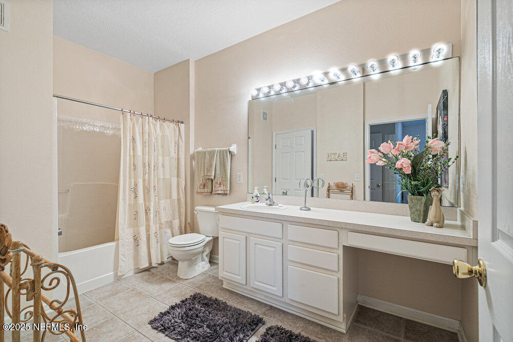 7801 Point Meadows Drive, Unit 3209 Jacksonville, FL 32256 - Photo 22 of 34 a bathroom with a sink and a mirror