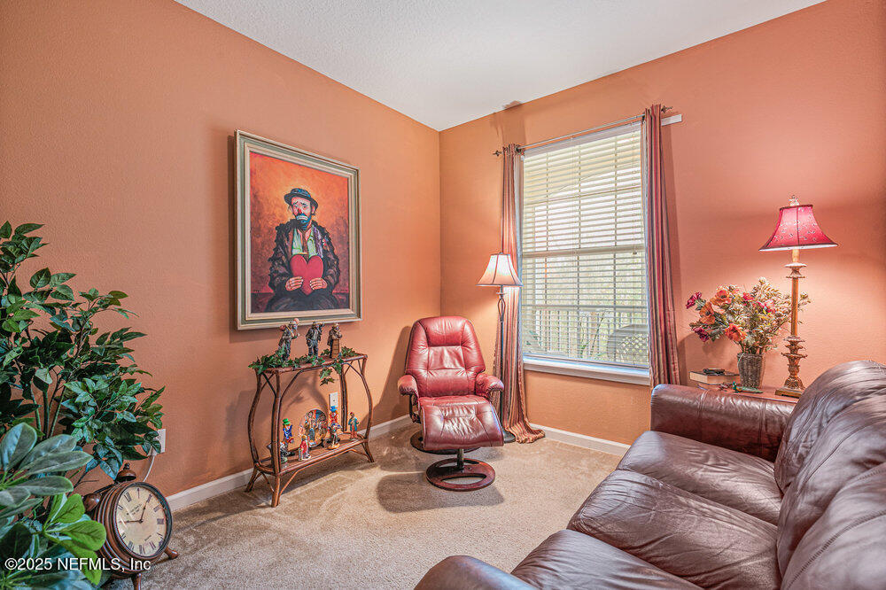 7801 Point Meadows Drive, Unit 3209 Jacksonville, FL 32256 - Photo 24 of 34 a living room with furniture a window and a potted plant
