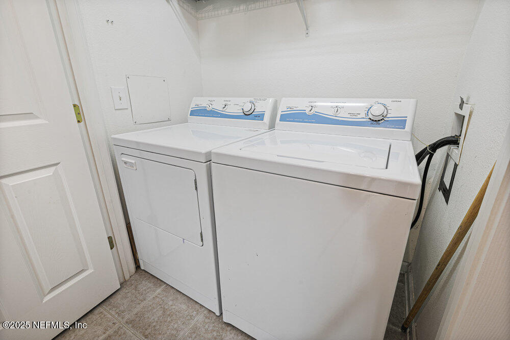 7801 Point Meadows Drive, Unit 3209 Jacksonville, FL 32256 - Photo 25 of 34 a utility room with dryer and washer