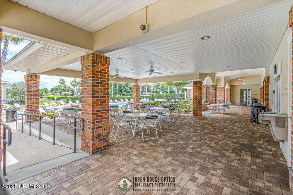7801 Point Meadows Drive, Unit 3209 Jacksonville, FL 32256 - Photo 32 of 34 a living room with furniture large windows and wooden floor