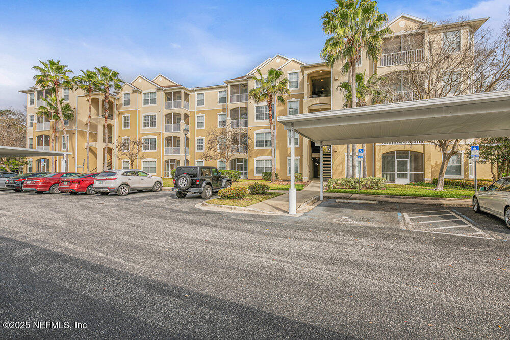 7801 Point Meadows Drive, Unit 3209 Jacksonville, FL 32256 - Photo 5 of 34 a front view of building with cars parked