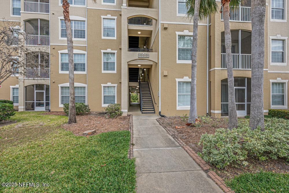 7801 Point Meadows Drive, Unit 3209 Jacksonville, FL 32256 - Photo 6 of 34 a front view of a house with a yard