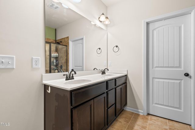 a bedroom with a bed dresser and a window