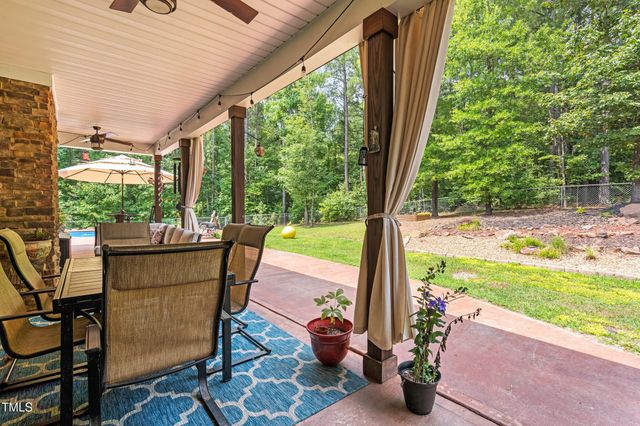 a spacious bedroom with a bed and a chandelier