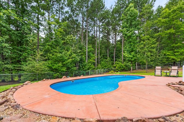 a view of a house with swimming pool and porch