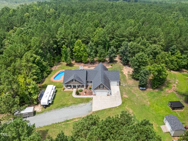 an aerial view of a house with yard swimming pool and outdoor seating