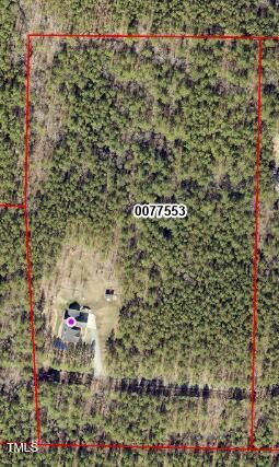 an aerial view of a house with garden space and street view