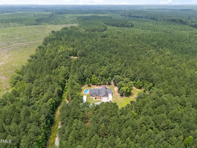 a aerial view of a house with a yard and a garden
