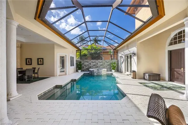 a very nice looking dining room with chandelier