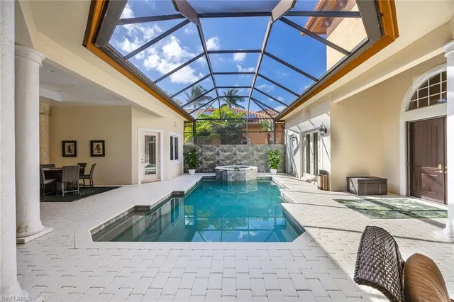 a bedroom with a large bed and a flat tv screen on dresser