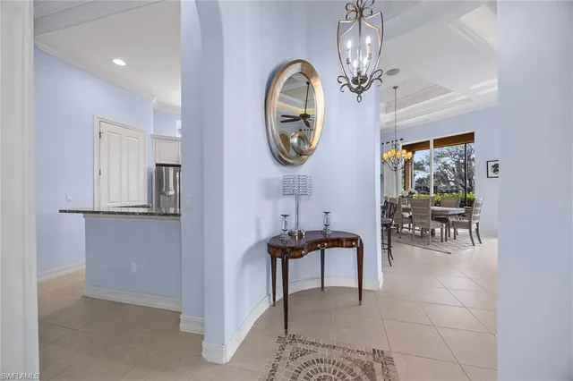 a bathroom with a granite countertop sink a toilet a mirror a vanity a window and shower