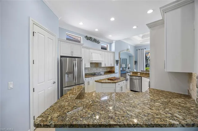 a bedroom with a bed and a mirror on the dresser