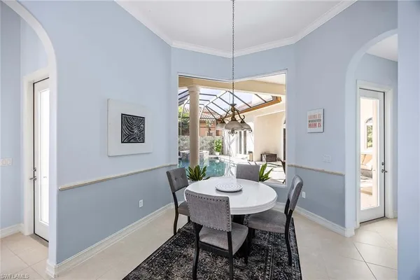 a view of a dining room with furniture large windows and wooden floor