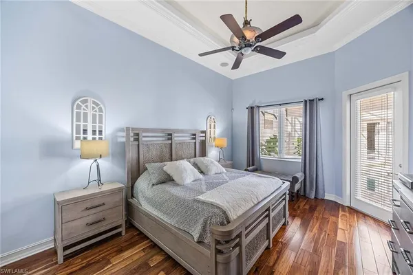 a bedroom with a large bed and a flat tv screen on dresser