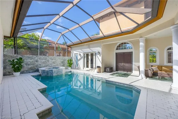 a view of a patio with table and chairs under an umbrella