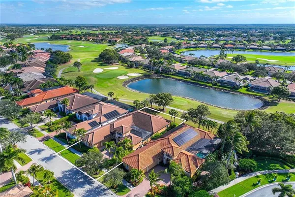an aerial view of residential houses with outdoor space and river
