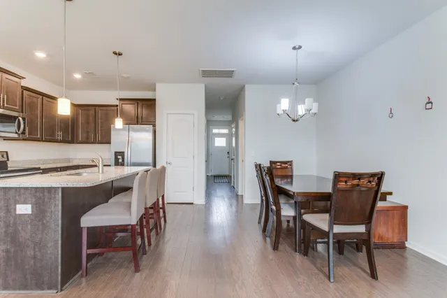 a living room with furniture large window and flat screen tv