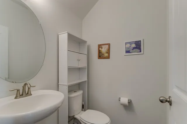 a white toilet sitting next to a bathroom sink