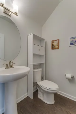 an empty room with an entrance to other room and fire place