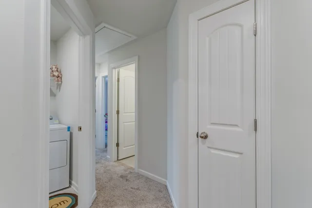 a view of a hallway to rooms