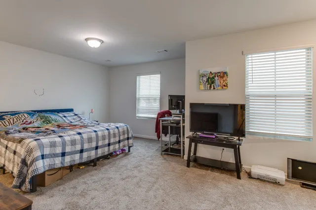 a bedroom with a bed and a tv on table