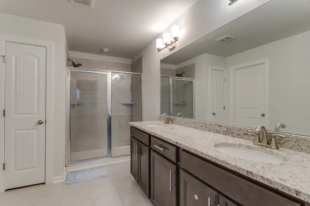 a bathroom with a glass shower door