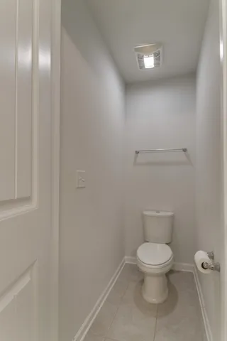 a bathroom with a granite countertop sink a light fixture and a mirror