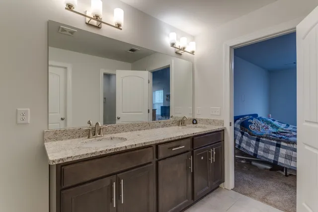 a bedroom with two bed and a window