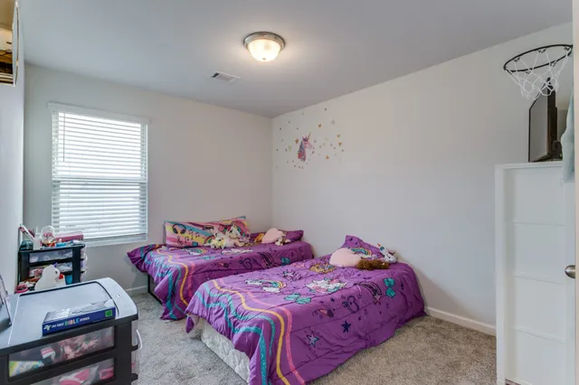 a bedroom with a bed and a television