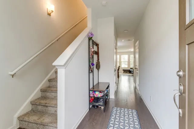 a hallway with a dining table chairs and entryway