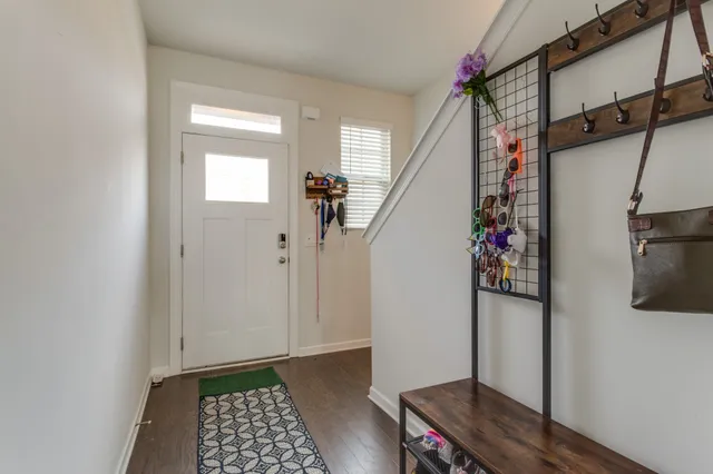 a view of entryway with wooden floor and stairs
