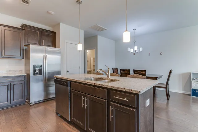 a dining table with chairs and wooden floor