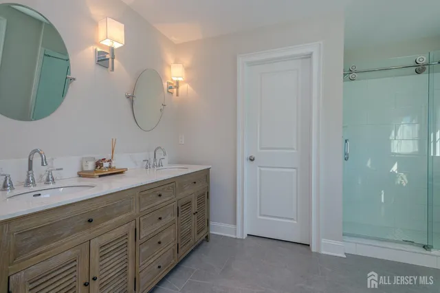 a spacious bedroom with a bed and a flat screen tv