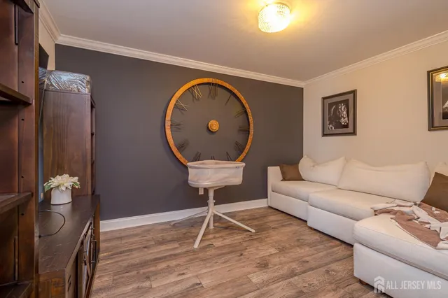 a view of a room that has a window and wooden floor