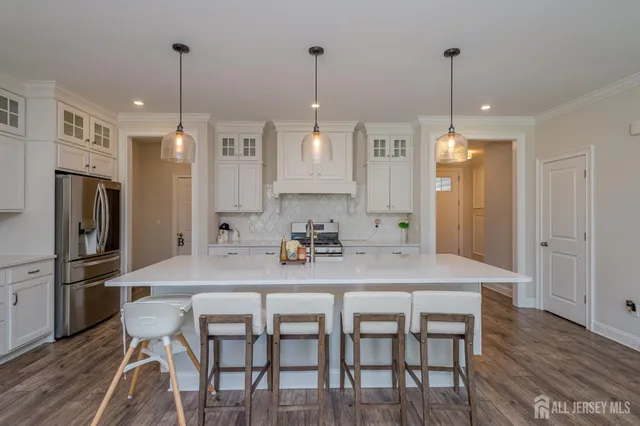 a view of kitchen with refrigerator table and chairs