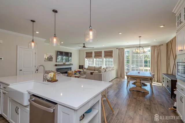 a kitchen with sink refrigerator and wooden floor
