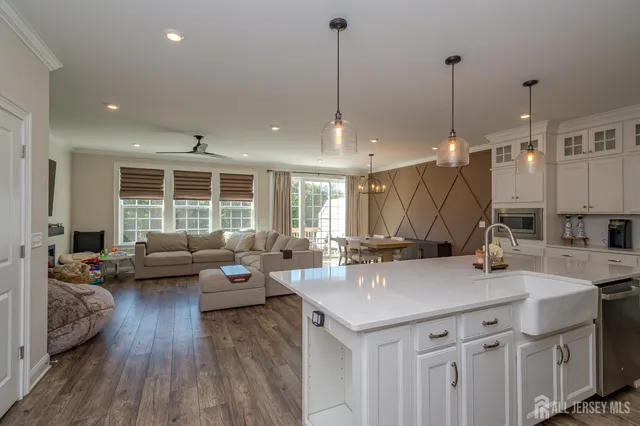 a view of a kitchen and living room with a wooden floor