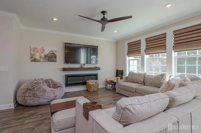 a living room with furniture a large window and a flat screen tv
