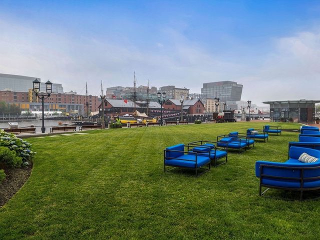 a view of a chair and table in the backyard