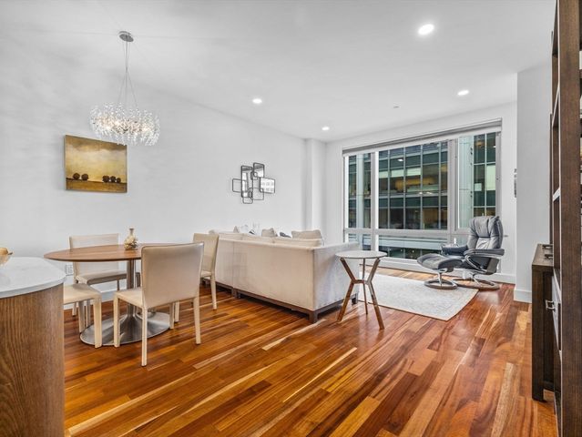 a living room with dining room and wooden floor