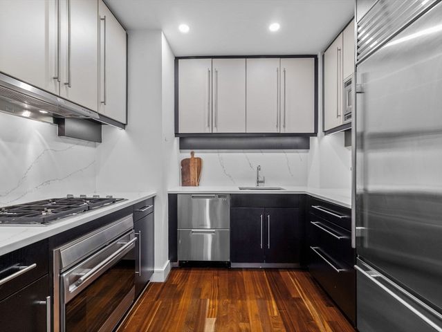 a kitchen with wooden cabinets and a stove top oven