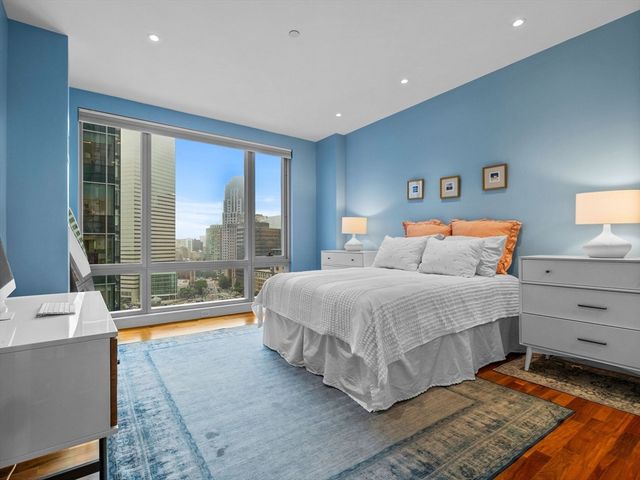 a bed room with a bed and a large window