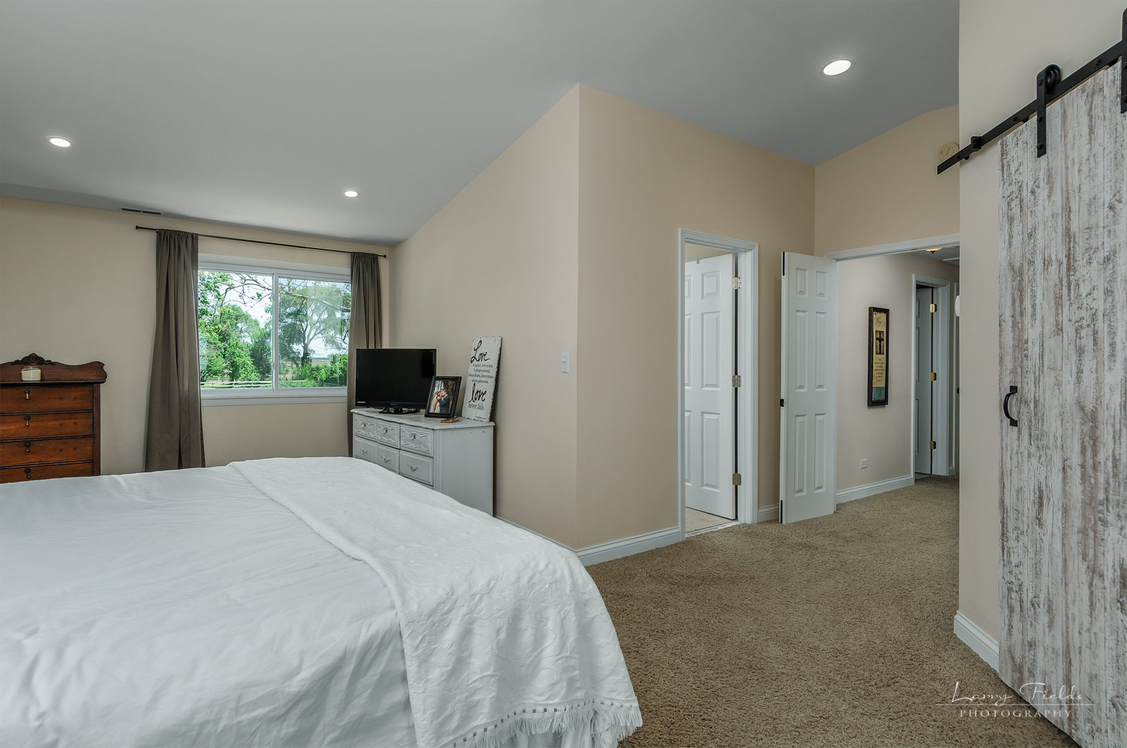 14725 Sears Road Plano, IL 60545 - Photo 11 of 26 a bedroom with a bed and a flat screen tv