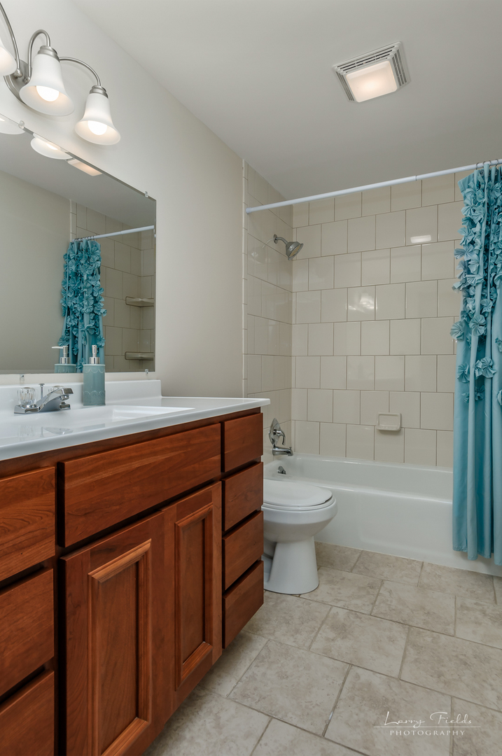 14725 Sears Road Plano, IL 60545 - Photo 15 of 26 a bathroom with a granite countertop sink toilet a mirror and bathtub